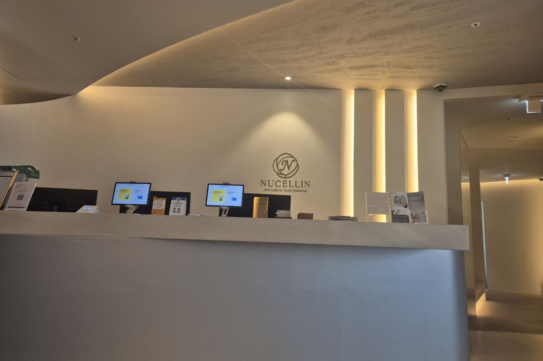 Nucellin reception desk beneath the clinic's logo and the line New Cells In. Youth Restored.