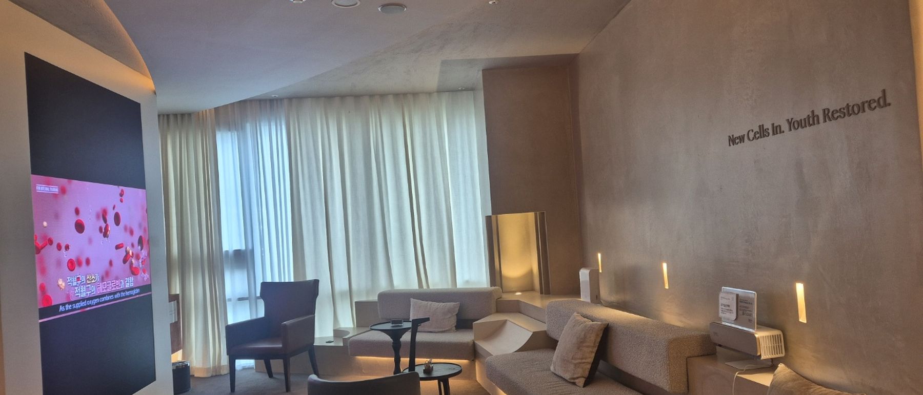 The Nucellin Hannam patient lounge, with the clinic's wall lettering reading New Cells In. Youth Restored.
